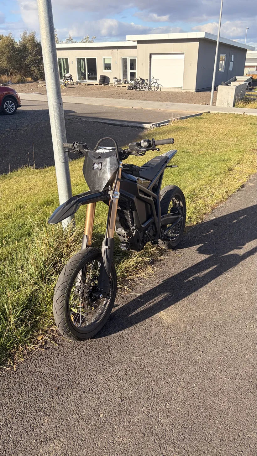 Rear brake caliper and bracket installed on Talaria Komodo